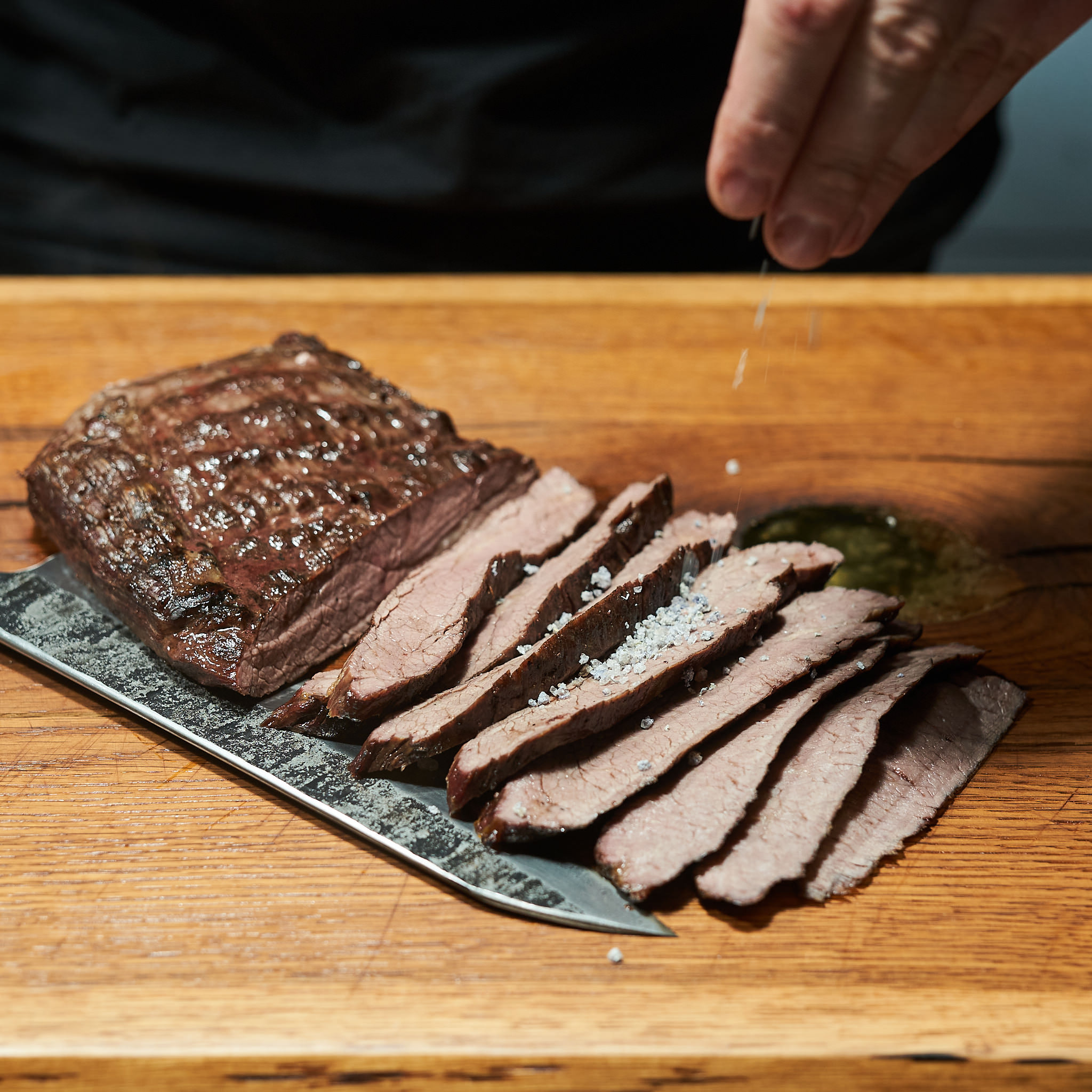 Gegrilltest Flat Iron Steak fein tranchiert und mit Meersalz verfeinert