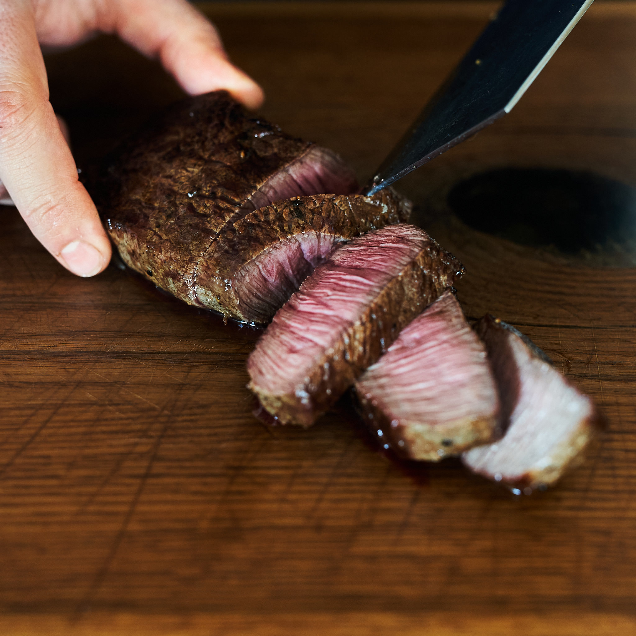 Gegrilltes Hueftsteak wird tranchiert